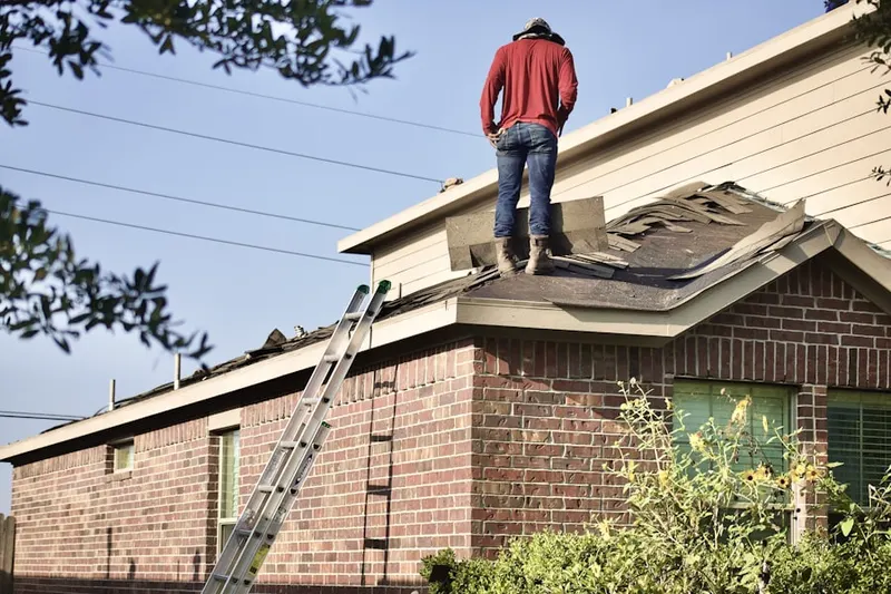 Professional roofer working on a residential roof in Merrimacport